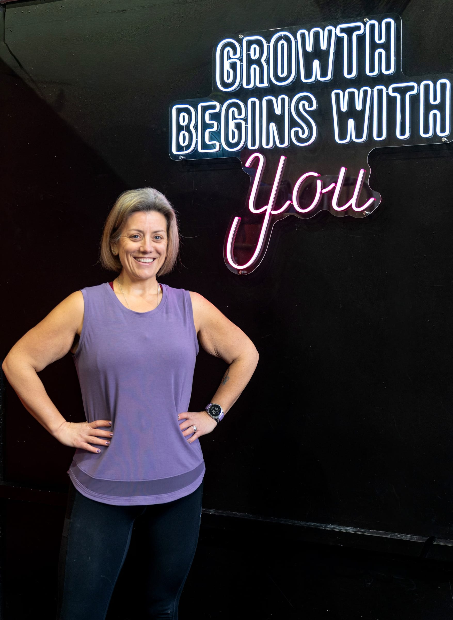 GAINS member moment near the neon sign